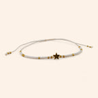 Bracelet en perles rocailles blanches et dorées avec perle étoile en métal doré  Bracelet Jethyka