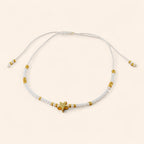 Bracelet en perles rocailles blanches et dorées avec perle étoile en métal doré  Bracelet Jethyka